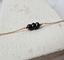 Gold chain bracelet with faceted black beads