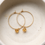 Gold-filled citrine hoop earrings in a ceramic dish