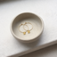 Gold hoop earrings with citrine in a ceramic dish