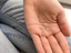 Hand holding a dainty gold-filled prehnite teardrop necklace