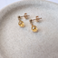 Close-up of faceted citrine briolettes on gold filled ball studs