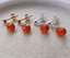 Close-up of carnelian teardrop stud earrings in gold-filled and sterling silver