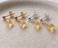 Gold filled and sterling silver citrine drop stud earrings lined up on a ceramic dish