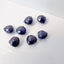 Several sapphire stones displayed on a white background