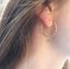 Labradorite charm hoop earring worn on the ear