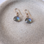 Faceted labradorite briolette earrings on speckled stoneware