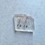 Labradorite dangle earrings on a clear crystal slab