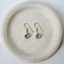 Gold-filled labradorite drop earrings on a speckled stoneware dish