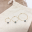 Labradorite hoop earrings in three hoop sizes on a linen pouch