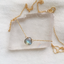 Labradorite pendant necklace on a clear crystal slab