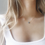 Dainty labradorite necklace worn with a white ribbed tank