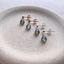 Labradorite stud earrings in 14k gold-filled on a ceramic dish