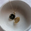 Gold filled round locket necklace open showing interior photo compartment, delicate pendant on fine chain