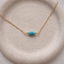Close-up of faceted turquoise rondelles hand wire-wrapped on a 14k gold-filled chain