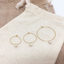 Opal hoop earrings in three hoop sizes on a linen pouch