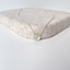 Dainty prehnite necklace in sterling silver with a faceted pale green prehnite heart on a textured stone display