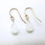     Close up of pear shaped moonstone drop earrings with luminous gemstones and gold filled ear wires