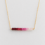 Gold-filled ombré ruby necklace showing the gradient from dark ruby to pale pink