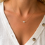 Dainty opal bead necklace in gold filled worn at the collarbone