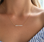 Gold filled opal beaded bar necklace worn at the collarbone