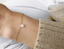 Opal teardrop bracelet worn on a sunlit wrist