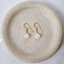 Dainty white opal teardrop drop earrings on speckled ceramic