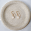 Faceted opal teardrop gold earrings on ceramic dish