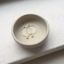 Opal hoop earrings on a speckled ceramic dish