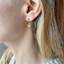 Dainty citrine teardrop stud earring in gold filled worn on the ear