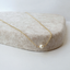 Close-up of a single freshwater pearl wire-wrapped on a gold-filled chain