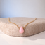 Gold filled pink opal teardrop necklace on a felt stand