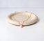 October birthstone pink opal teardrop necklace on a speckled dish