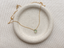 Gold-filled prehnite teardrop necklace with spring ring clasp on a speckled ceramic dish