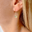 Close-up of a prehnite heart drop earring in 14k gold-filled worn on the ear