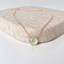 Dainty prehnite necklace in 14k rose gold-filled with a faceted mint green prehnite heart on a textured stone display