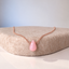Rose gold filled pink opal teardrop necklace on a felt stand