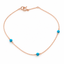 Turquoise station necklace in rose gold filled with three genuine turquoise beads hand wire-wrapped along a dainty cable chain, on a white background