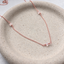 Rose gold-filled cubic zirconia station necklace on a speckled ceramic dish