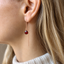 Rose gold-filled garnet threader earring worn on the ear