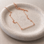 Rose gold filled opal beaded bar necklace on a ceramic dish