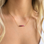 Model wearing the gold-filled ombré ruby necklace at the collarbone
