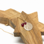 Personalized ruby initial necklace on a gold-filled cable chain resting on a wooden star