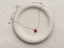 Ruby teardrop necklace in sterling silver on a speckled ceramic dish