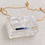 Gold-filled ombré sapphire necklace with spring ring clasp displayed on a clear crystal