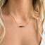 Model wearing the gold-filled ombré sapphire necklace at the collarbone