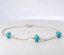 Turquoise station bracelet in sterling silver with three faceted turquoise rondelles on a fine cable chain