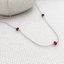 Garnet 3 bead station necklace in sterling silver with three faceted garnet beads