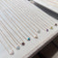 Close up flat lay of dainty gold filled gemstone necklaces showing rose quartz turquoise and amethyst options