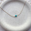 Dainty 14k gold filled single turquoise gemstone necklace on ceramic dish