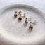 Smoky quartz stud earrings in 14k gold-filled and sterling silver on a stone dish